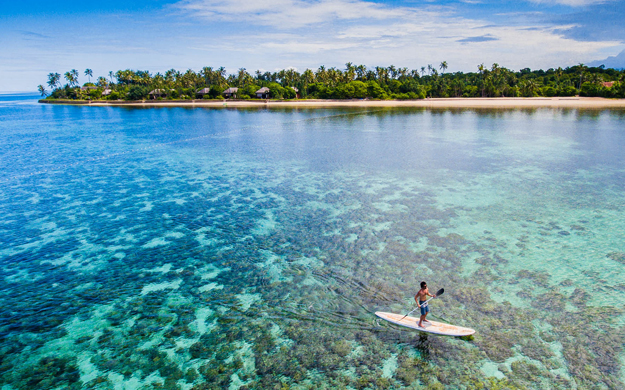 Paddleboarding, and other activities such as kayaking, are included in your standard accommodation package. Photo by Wakatobi Resort