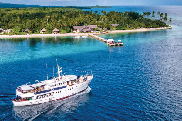 The Pelagian dive yacht passing front of its home port, Wakatobi Dive Resort.