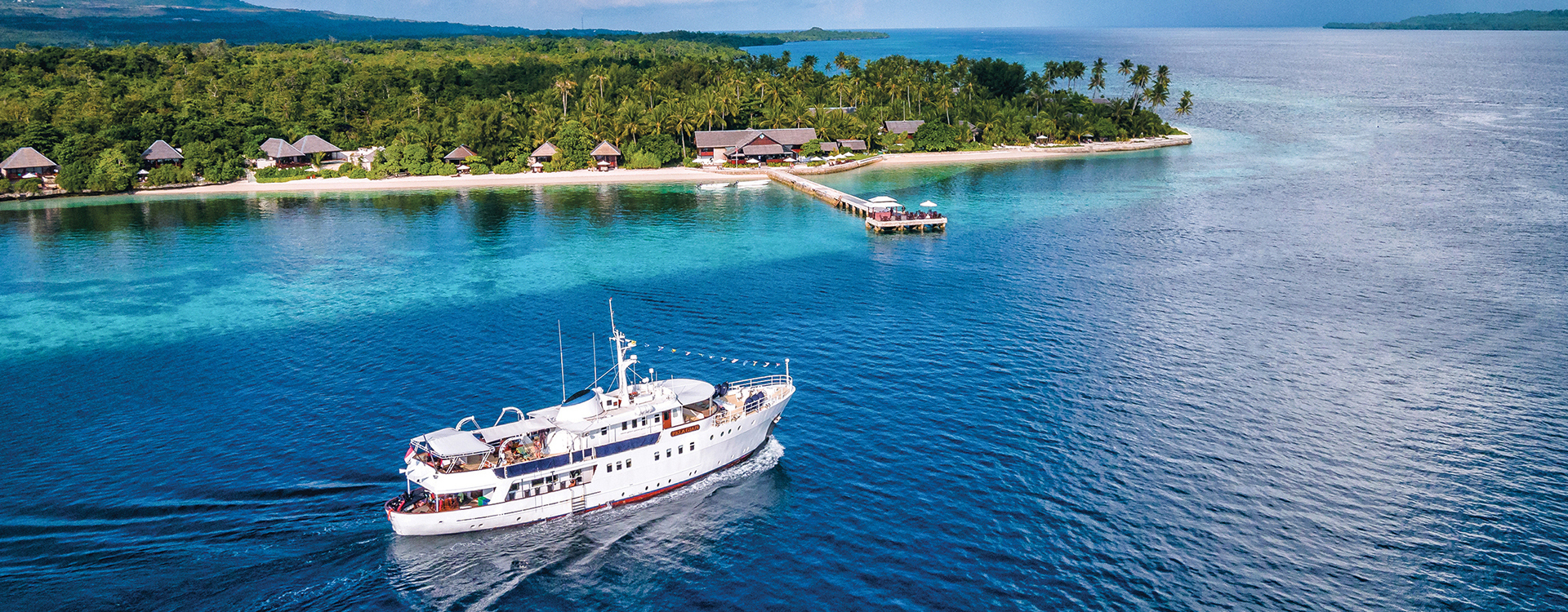 The Pelagian dive yacht passing front of its home port, Wakatobi Dive Resort.