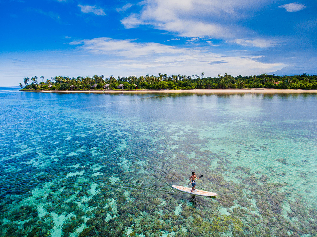 Paddleboarding across the Wakatobi House Reef provides unforgettable views above and below the surface. 