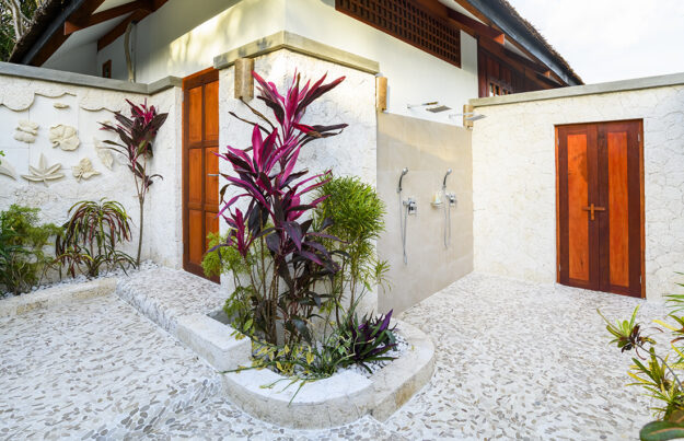 Asian-style outdoor shower gardens feature a pair of rainfall shower heads and a separate outdoor entrance from the beach. This is ideal for swimmers and divers who don't want to track sand and water through the bungalow. Photo by Wakatobi Resort
